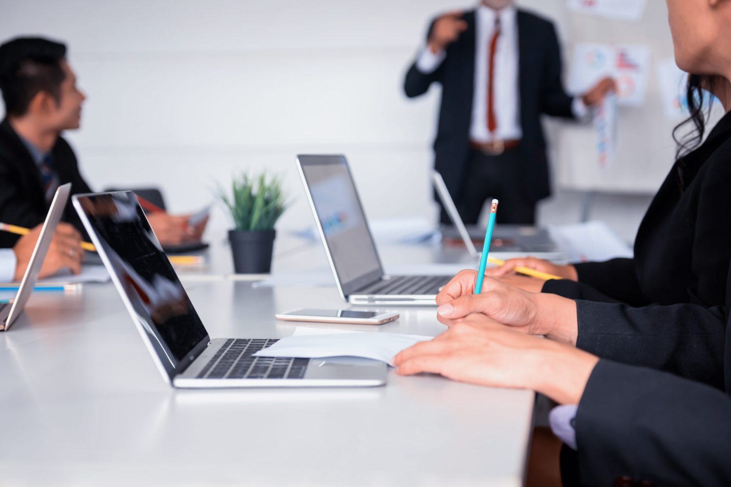 Businesspeople meeting and discussing with colleagues in conference room